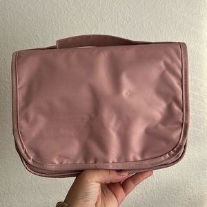 Small bag, but has a lot of pockets, light pink color